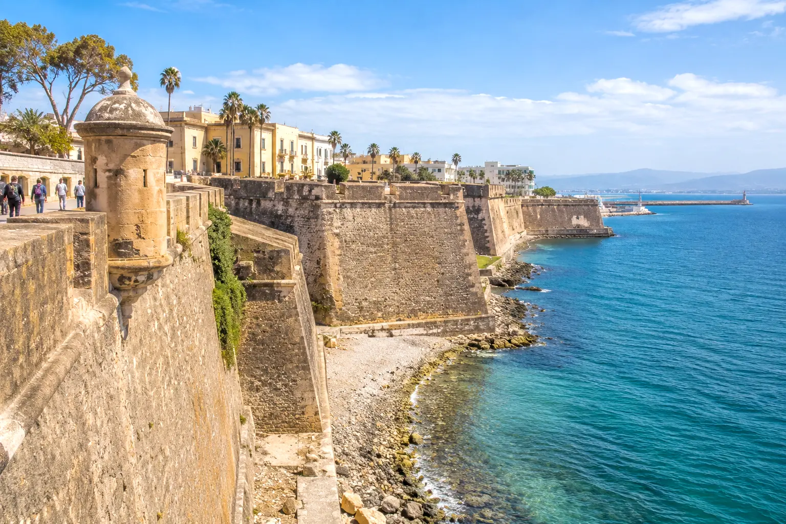 Historic Royal Walls of Ceuta stone fortifications and watchtower over the Mediterranean shore in Spain.